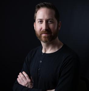 John Colbert, author of the memoir Damaged Goods, which explores grief and healing through humor.