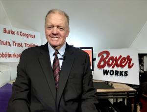 Election candidate seated on desk introduced in Boxer Works start up on video