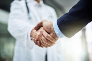 Close-up of a man shaking hands with a physician, representing confidential, professional, and patient-focused men’s health care at Performance Center for Men.