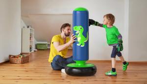 A father and his young son playing together with a QPAU inflatable punching bag during an active, screen-free moment at home.