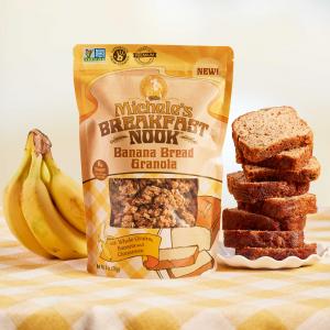 Michele's Breakfast Nook Banana Bread Granola on a table with the oven-baked load that inpired this flavor