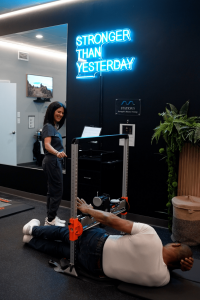 Clinician supervising isometric strength testing using the VALD ForceFrame at MetaLab inside Confidia Health Institute in Bristol, Connecticut.