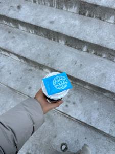 Body wipes stacked on top of a to-go coffee cup.