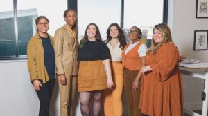 The diverse Creative Repute team - design and digital agency professionals standing together in a bright office setting.
