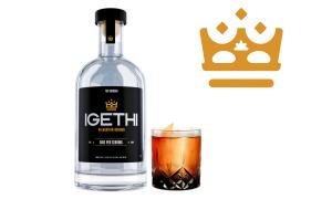 A bottle of IGETHI spirits with a highball cocktail glass with soda mixer