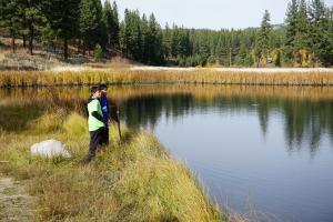 Students explore Grizzly Pond during their pond ecology science lesson