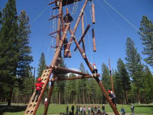 Students build confidence climbing the Alpine Tower on the challenge course