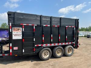 Side view of a KDR roll-off dumpster trailer designed for construction and renovation waste.