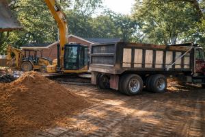 Dirt hauling services loading soil into a dump truck during site preparation in Columbus, GA
