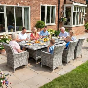 Garden furniture outdoor dining set by Rattan Garden Furniture LTD Essex in a residential garden
