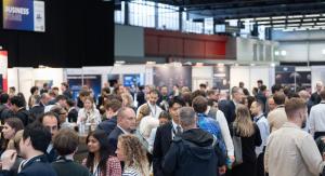 Attendees networking on the SmallSat Europe exhibition floor