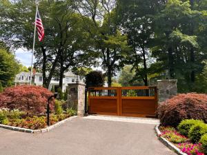 Custom wood and iron residential driveway gate installed by a Perimeter Holdings USA portfolio company.