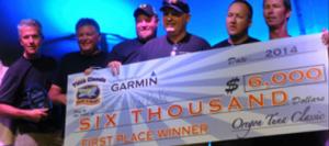Mike and crew pictured winning the Oregon Tuna Challenge in 2014 - with $6,000 prize money check they donated to the Oregon Food Bank along with all their tuna which was processed