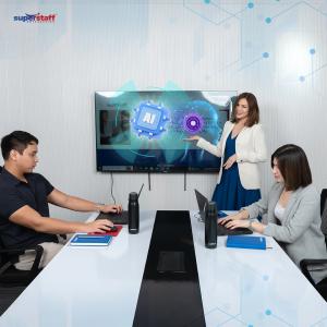 SuperStaff employees collaborating on AI tasks and data dashboards