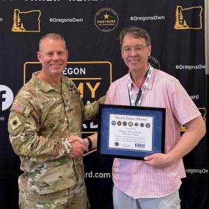 Joseph Wyno, Executive Director of the Oregon UAS Accelerator, receiving The Seven Seals Award from General Alan R. Gronewold, The Adjutant General, Oregon National Guard
