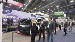 Interview in progress at CES 2026 Mobility Stage with Pliyt autonomous vehicle and production crew