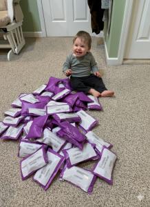 Alexandra's son, Owen, helping pack Binkiband orders to ship out.