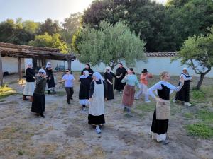 a group of sisters in the courtyard of La Purisima mission practicing tai chi