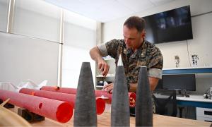 U.S. Marine Corps Maj. Dillon Pierce, a master’s and doctoral graduate of NPS, prepares experimental rockets for test flight while completing his doctorate in space systems engineering in June 2025. An infantry officer by trade, Pierce’s dissertation expl