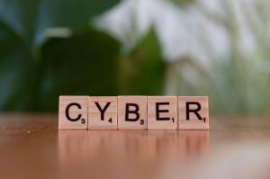 Scrabble tiles spelling “CYBER,” symbolizing cybersecurity fundamentals.