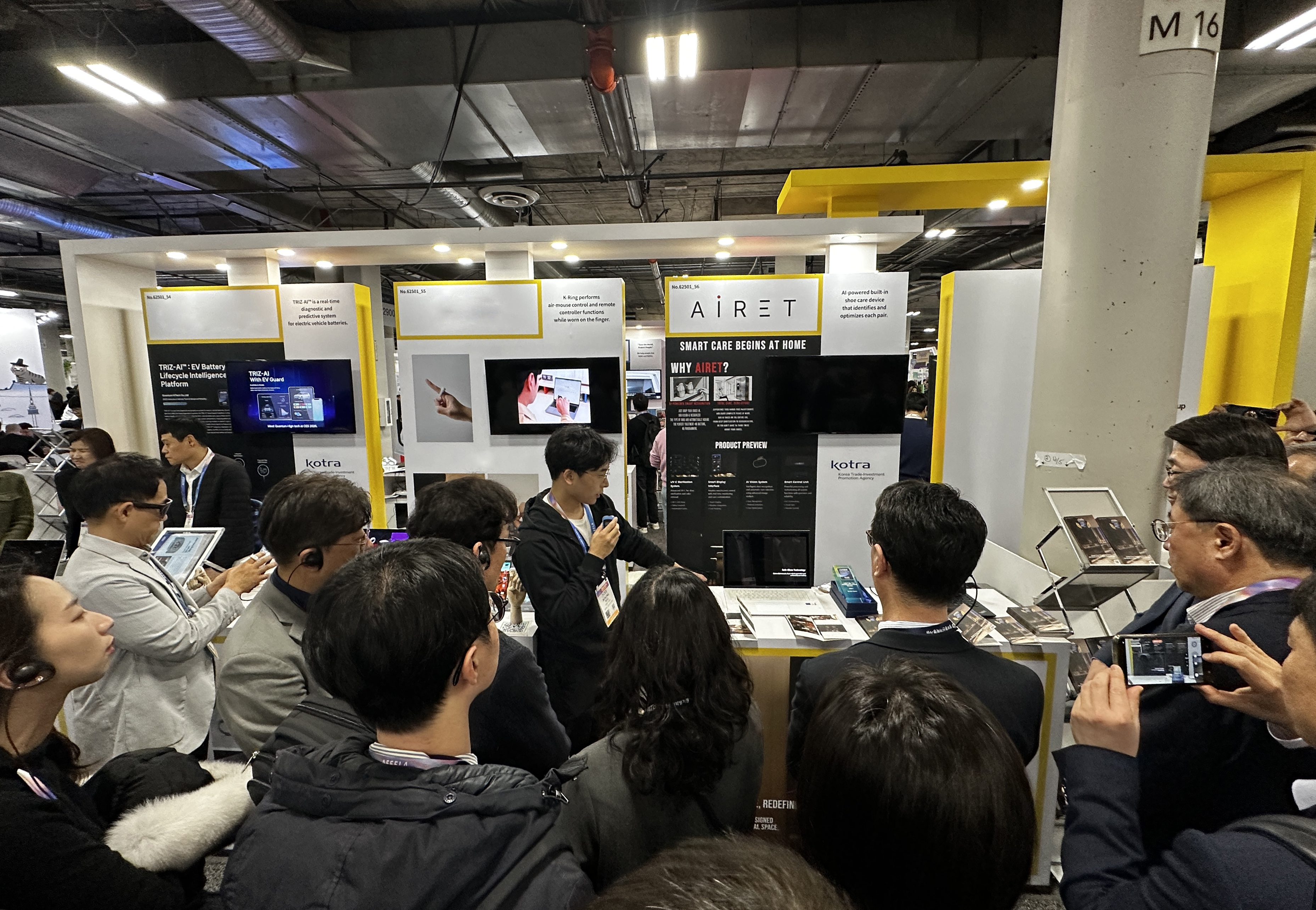 Bon-ung Koo (Austin Koo), CEO of Airet, presenting at the Airet booth at CES 2026 as a crowd of attendees gathers to listen