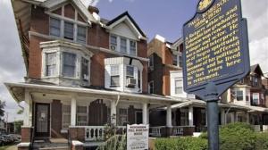 Exterior of the Paul Robeson House & Museum in West Philadelphia with a historical marker visible.