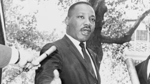 Dr. Martin Luther King Jr. speaking to a large crowd during a historic public gathering.