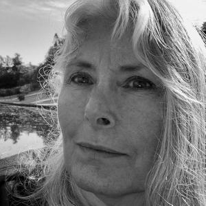 Black-and-white portrait of author M. E. Torrey, shown outdoors in close profile with a calm, reflective expression.