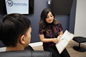 Markham Naturopath Dr. Wendy Zhou Consulting a Client at HealthyToDos