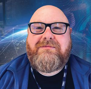 The image is a photo of TMC Technologies Dahlgren Site Lead, Mike Mitchem