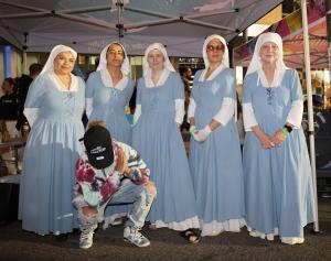an image of a man on bended knee for photo with the sisters