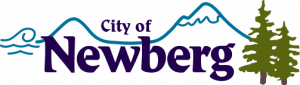 logo showing a mountain and the words city of newberg with some pine trees and water