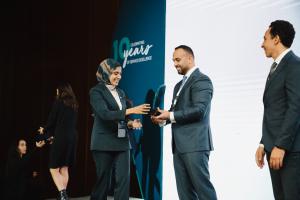 A Diverse Supplies employee receives an award for contribution to achievement of energy saving targets.