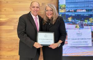 Rosemont Mayor Bradley A. Stephens joins Lisé Puckorius, CAE, CEO of the OLC, at the Rosemont Village Hall holding the IACC plaque