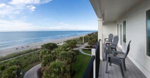 Balcony with chairs overlooking the ocean.
