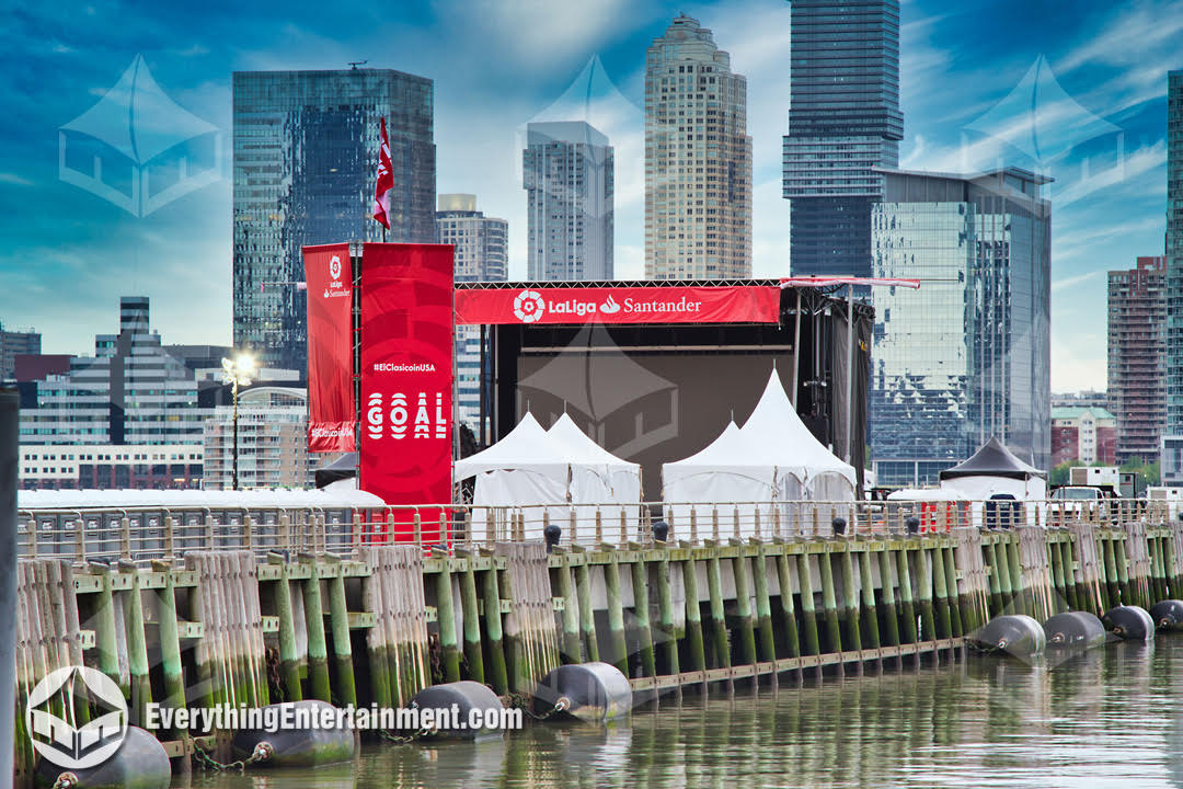 A photo of soccer watch party infrastructure including tents and stage