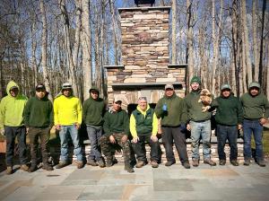 Team members from Jim Dunphy's Landscaping standing on a paved patio.