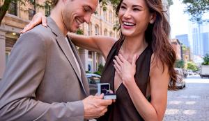 Man proposing a woman with an engagement ring from with clarity purchased during valentine's day sale