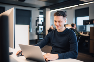 Software engineer sitting in Softeta's office