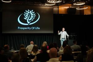 Shane Krider of Prosperity Of Life on stage at a company hosted event