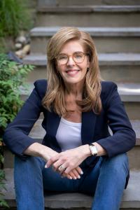 Kate Scharff, LCSW, sitting on steps