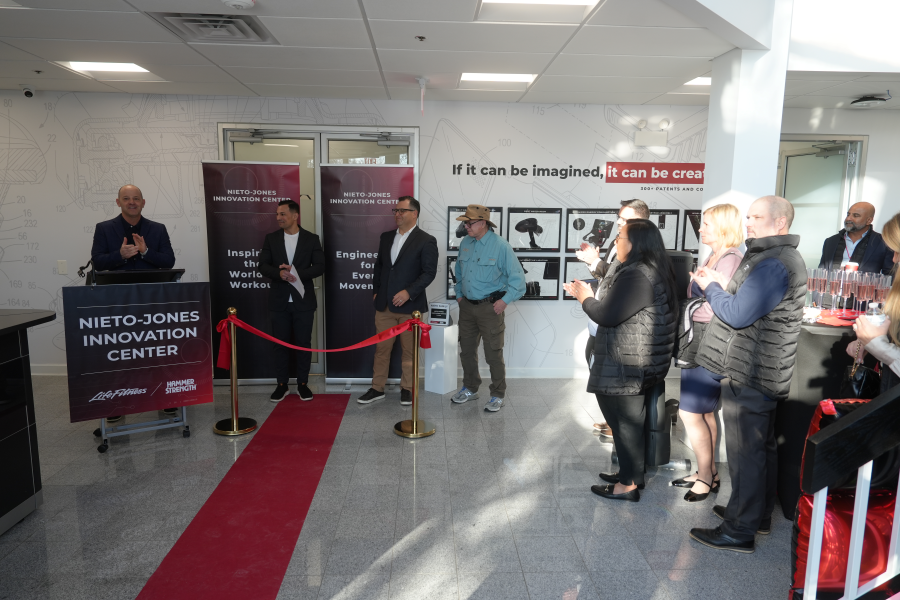 Honorees and guests listen to company executives deliver their speeches at the opening of the new facility.