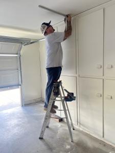 Brown’s Garage Door team repairing a garage door, demonstrating teamwork and professional service