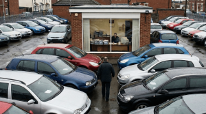Independent UK car dealership forecourt with rows of used cars, as dealers face rising online vehicle advertising costs.