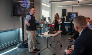 Ross Anthony Eldred, a faculty associate for research in the Naval Postgraduate School Department of Systems Engineering, showcases the WIEVLE 3D-printed autonomous underwater robot, which features several patented technologies.