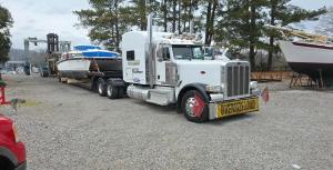 Catamaran boat being loaded for transport.