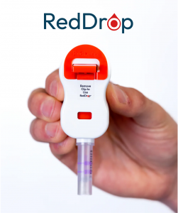 RedDrop ONE FDA-cleared blood collection device shown in hand, designed for painless, remote capillary blood collection.