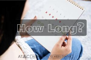 Person holding a calendar with several dates crossed off and circled, symbolizing the timeline and duration of antidepressant withdrawal or medication tapering.