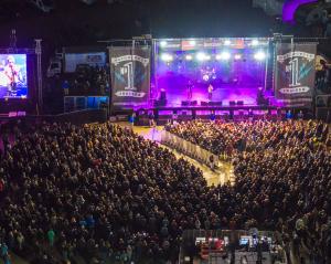 A large crowd gathers in front of a concert stage at the Rockyard