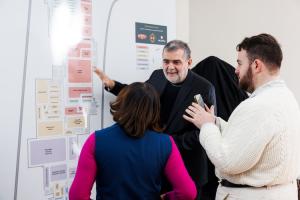 Cristiano Creminelli shows guests a map of the 561,444-square-foot production facility and campus in Mapleville, RI